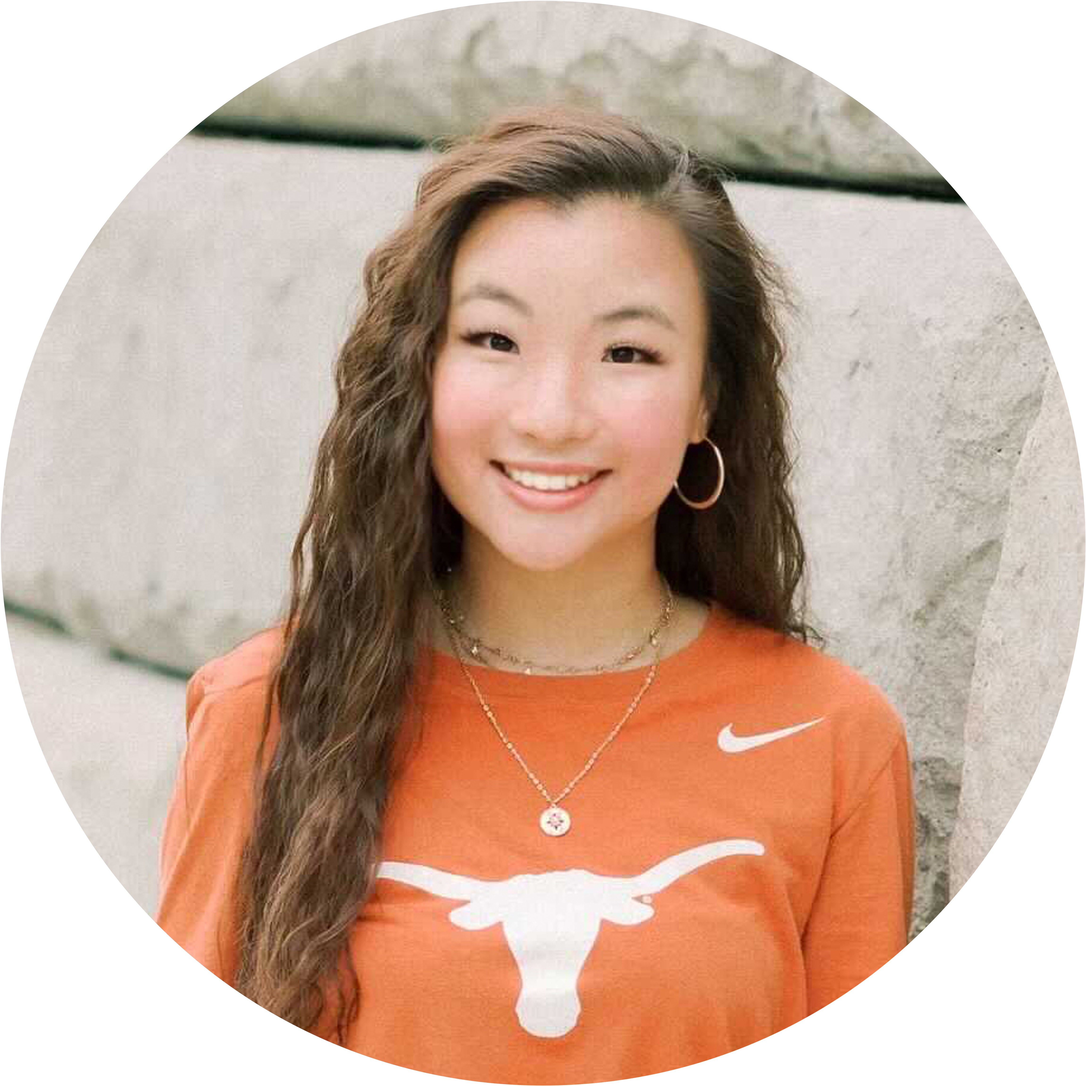 Melody Zhuo, smiling while wearing a UT Austin t-shirt